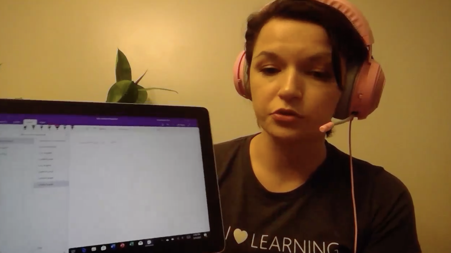 Student sitting in front of computer wearing headphones