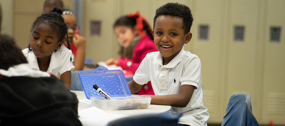 Another elementary school boy smiling