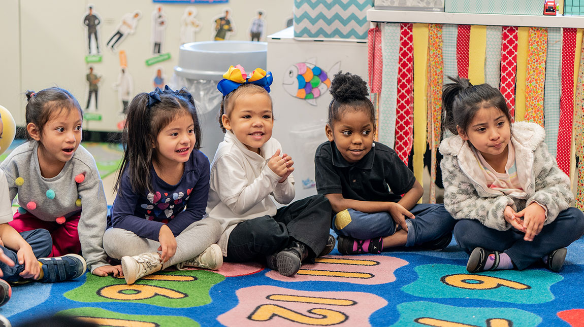 Pre-K girls sitting down